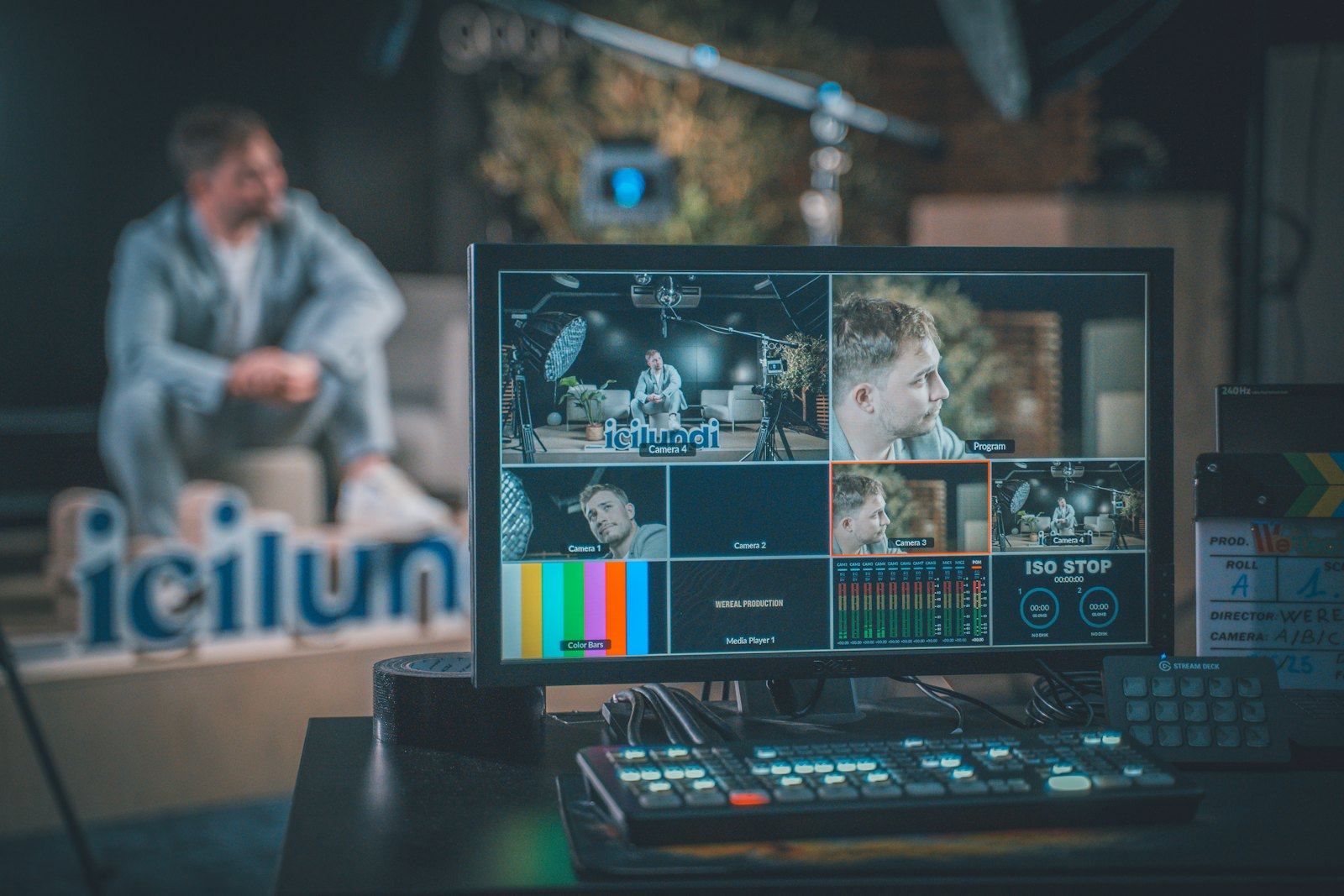 Production studio with a multiviewer and vision mixer panel in the foreground
