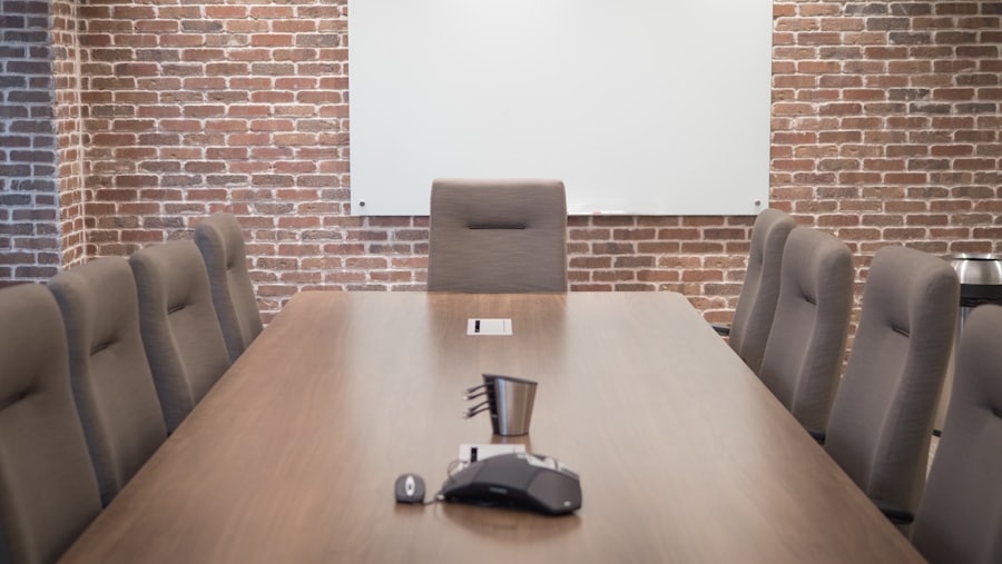 Boardroom table with a conferencing microphone and a wall-mounted screen